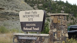 A sign for Shell Falls Interpretive Site in the Bighorn National Forest, managed by the U.S. Department of Agriculture. - Paloma on Main — Downtown View, Sheridan WY (Sheridan)
