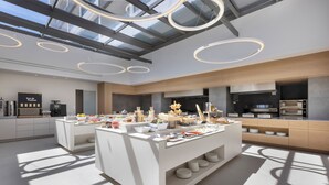 A modern kitchen with a central island, built-in appliances, and a skylight. - Mirage Chalkida City Resort (Chalcis)