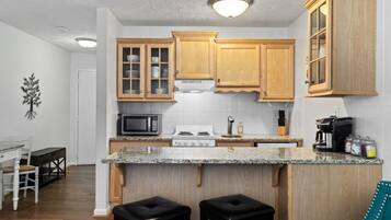 Fridge, microwave, coffee/tea maker, cookware/dishes/utensils