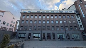 A multi-story building with a symmetrical facade, large windows, and a central entrance. - Ralf Sannikov Apartment (3A) (Tartu)