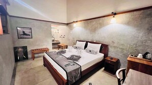 A bedroom with a bed, bedside tables, a desk, and a chair. - Yala Leopard Lodge (Kirinda)