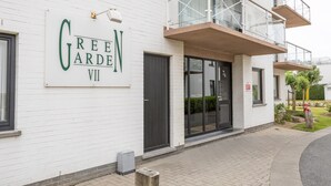 A building with a sign reading "Green Garden VII". - Ground Floor Apartment With Sunny Terrace (Middelkerke)