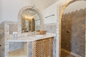 Een douche, een bidet, handdoeken, shampoo