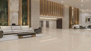 A spacious lobby with a modern sofa, a coffee table, and a seating area.