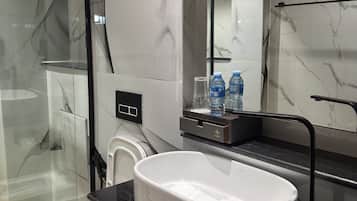 Business Suite, Balcony, City View | Bathroom | Slippers, towels, soap, shampoo
