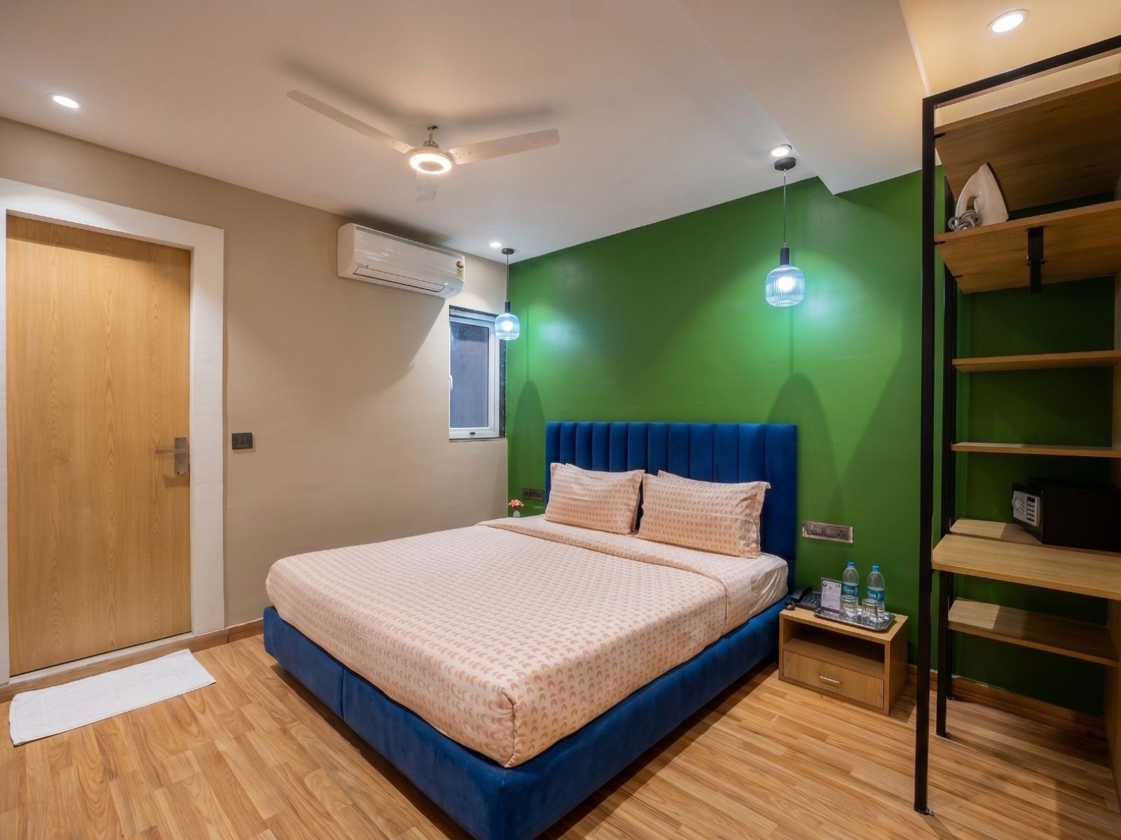 A bedroom with a bed, a wardrobe, a nightstand, and a ceiling fan.