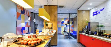 A breakfast buffet with various food items and a counter with a sign reading 'Express Start Breakfast'.