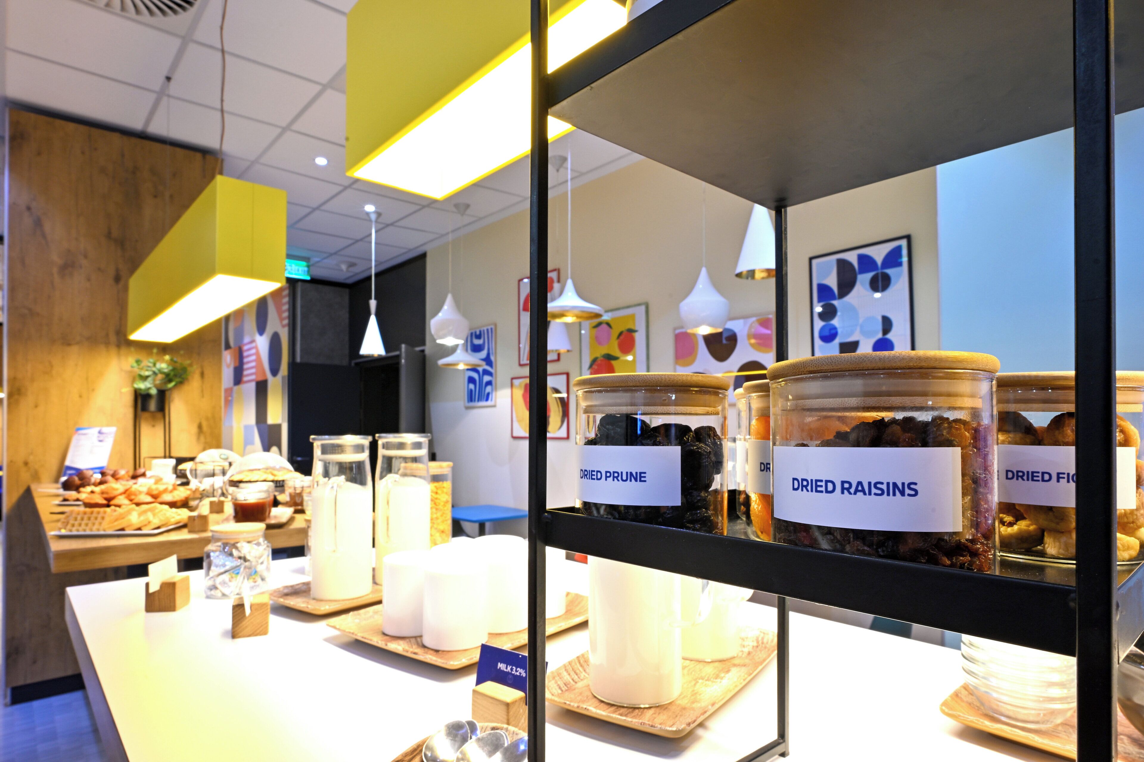 A breakfast buffet with various food items and a sign indicating 'Dried Prune'.
