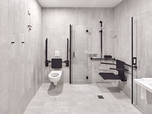 A modern bathroom with a toilet, a shower area, and a sink. - B&B HOTEL Arnsberg (Arnsberg)