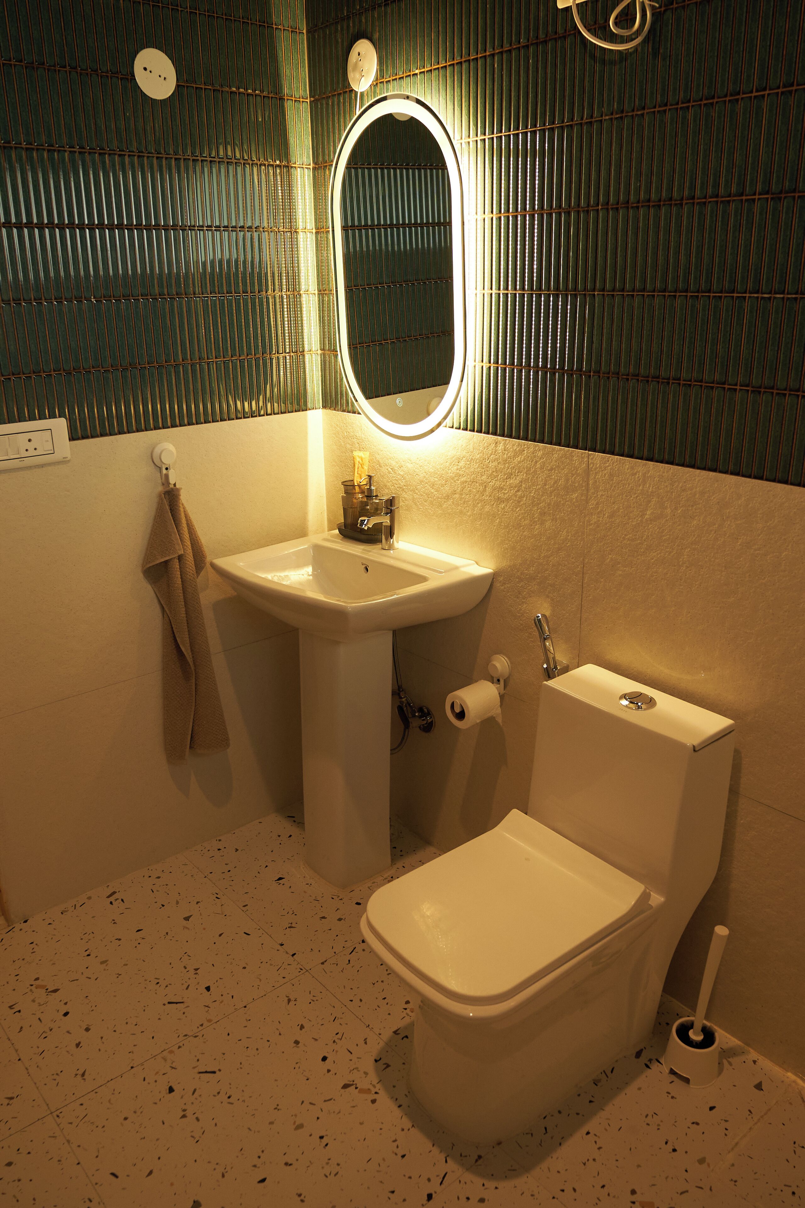 A bathroom with a sink, toilet, and mirror.