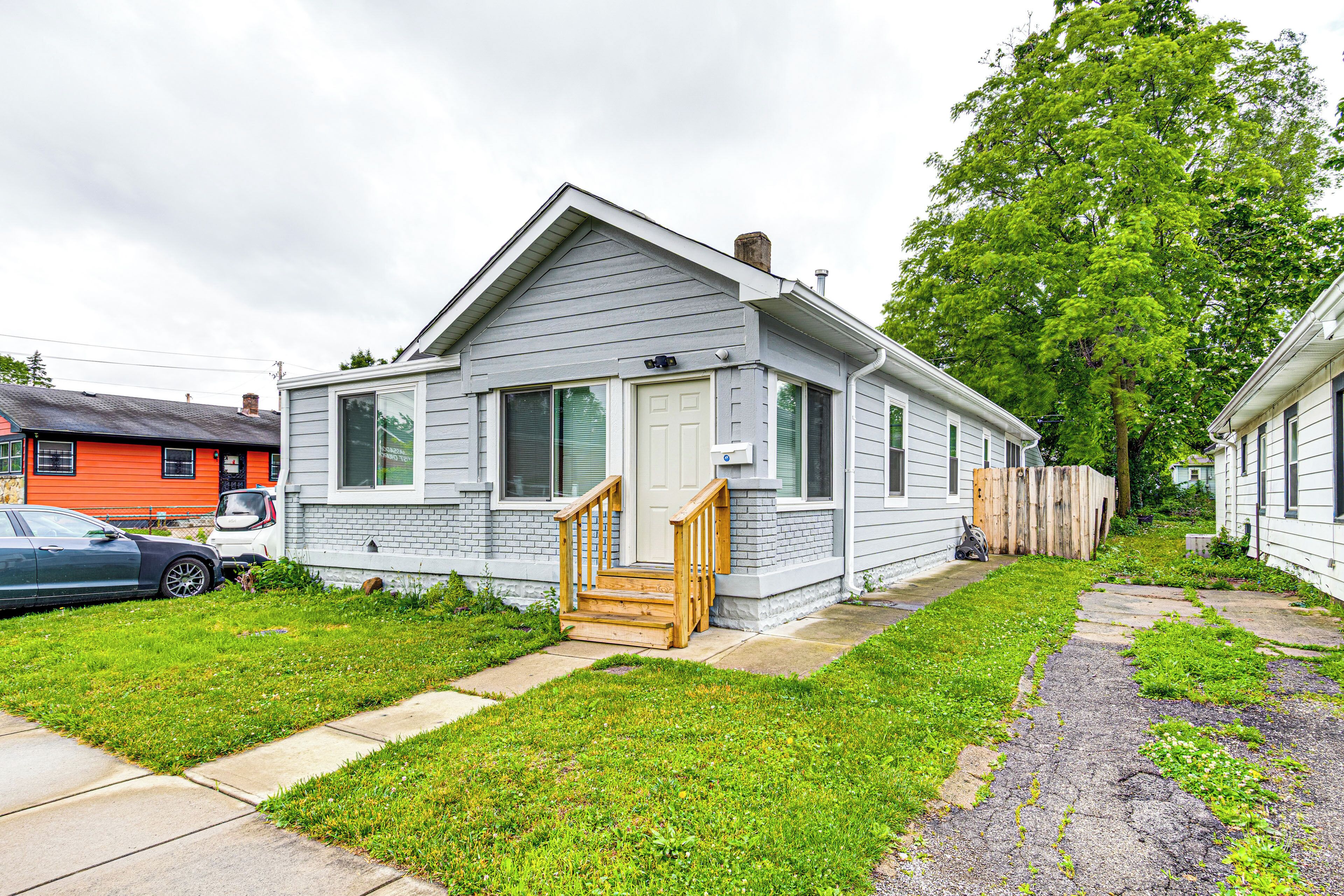 A single-story house with a front porch and a small front yard.