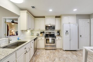 A kitchen with white cabinets, stainless steel appliances, a granite countertop, and a tiled floor. - 4 Mi to Downtown Panama City: Home w/ Patio! (Panama City)