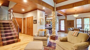 A spacious living area with a staircase, wooden ceiling, and a cozy seating arrangement. - White River Access & Views: Retreat w/ Shared Dock (Gassville)