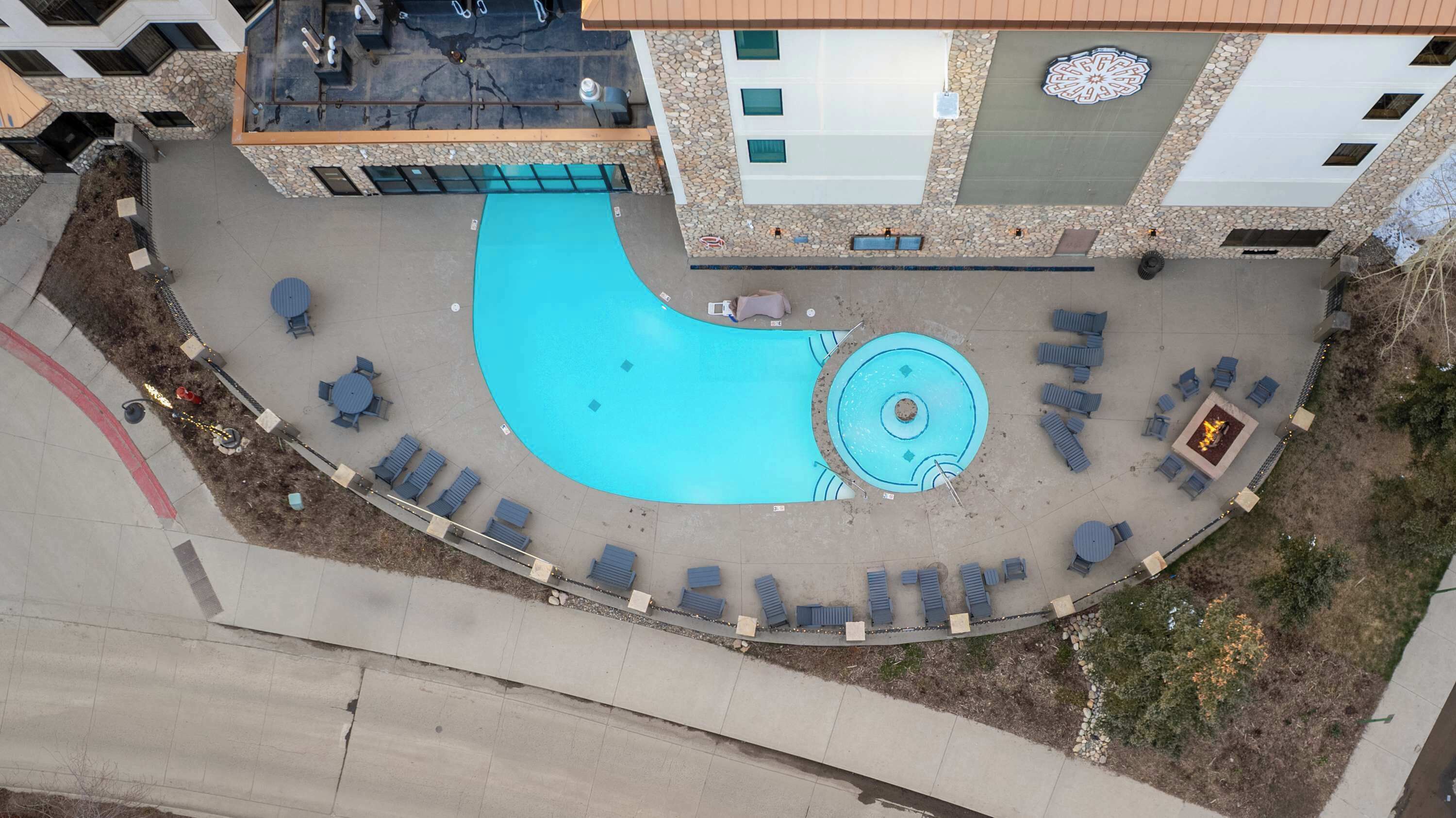 【Pool Deck】Lounge chairs and the hot tub — same complex, different view