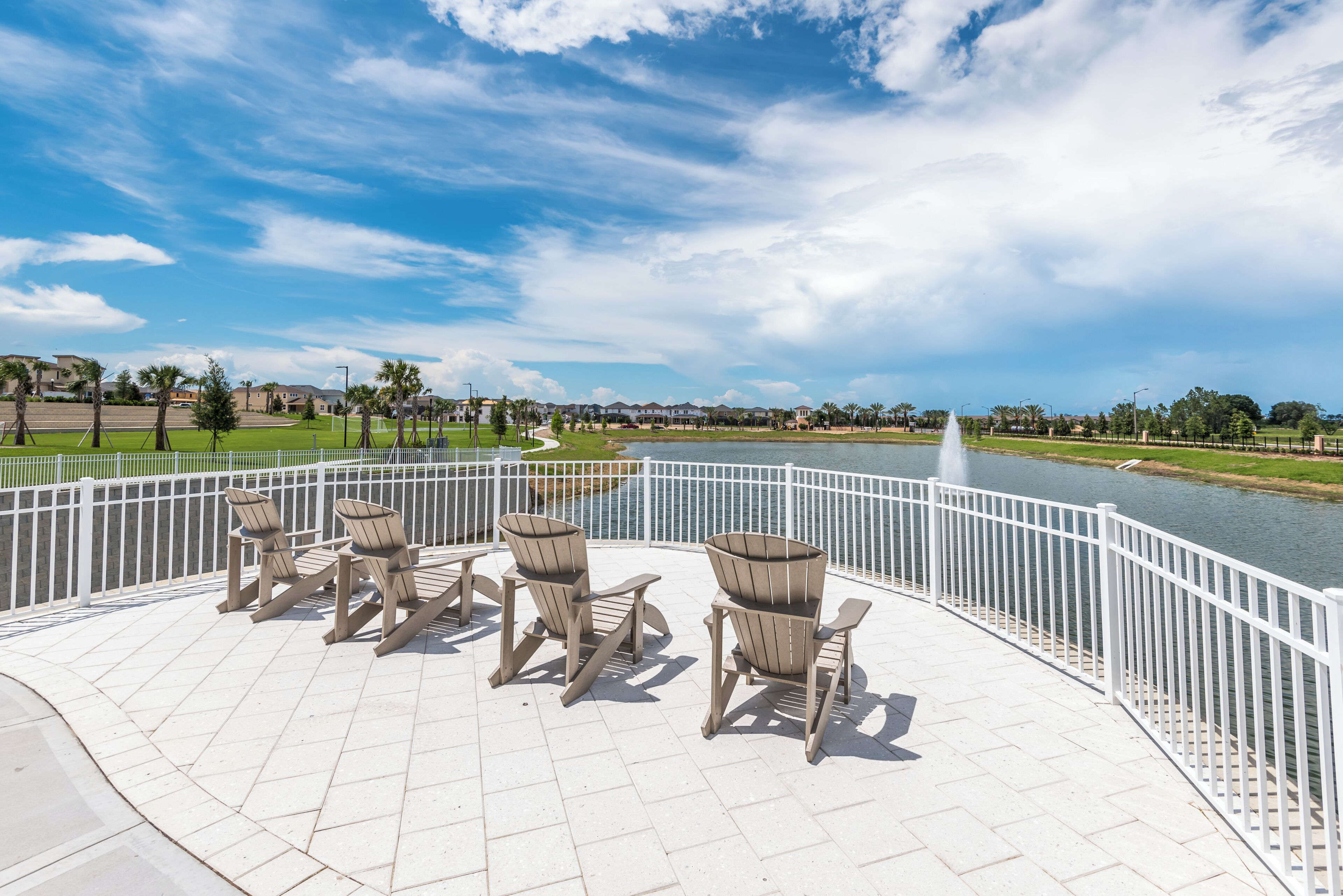 A waterfront patio with outdoor seating and a view of the river.