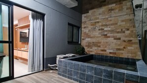 A modern interior with a tiled floor, a built-in bench, and a small window.