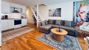 A modern apartment with a kitchen, living area, and a staircase. - Brilliant family getaway in Stockholm - 4 Guests (Kista)