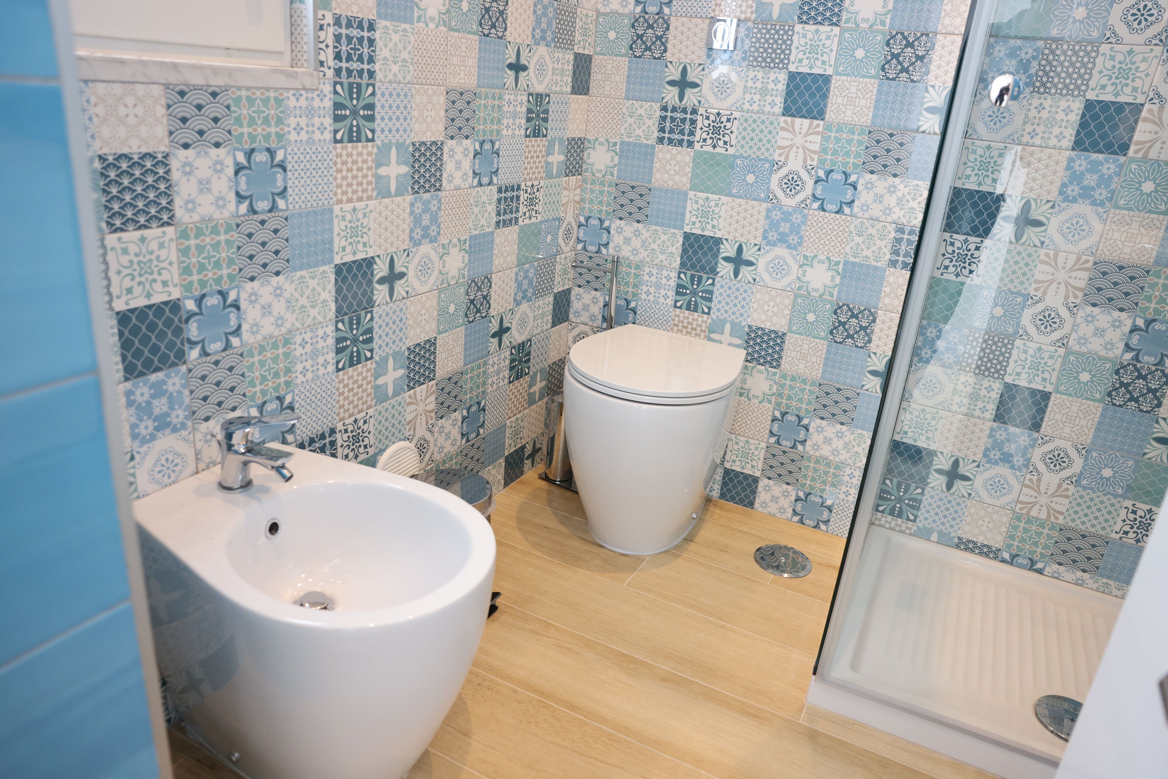 A bathroom with a sink, toilet, and shower area.