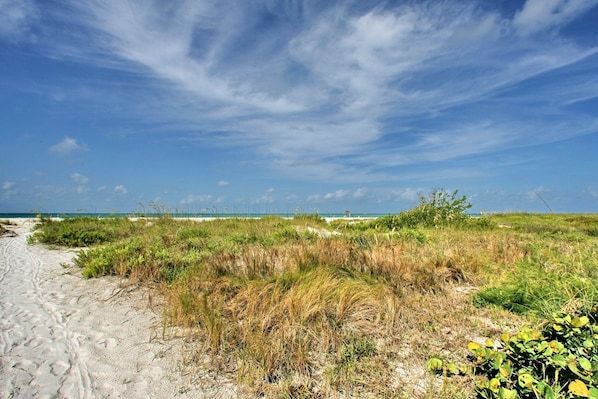 A sandy beach path with sparse vegetation and a clear sky. - Jersey Gal 3 Bedroom Home (Anna Maria)