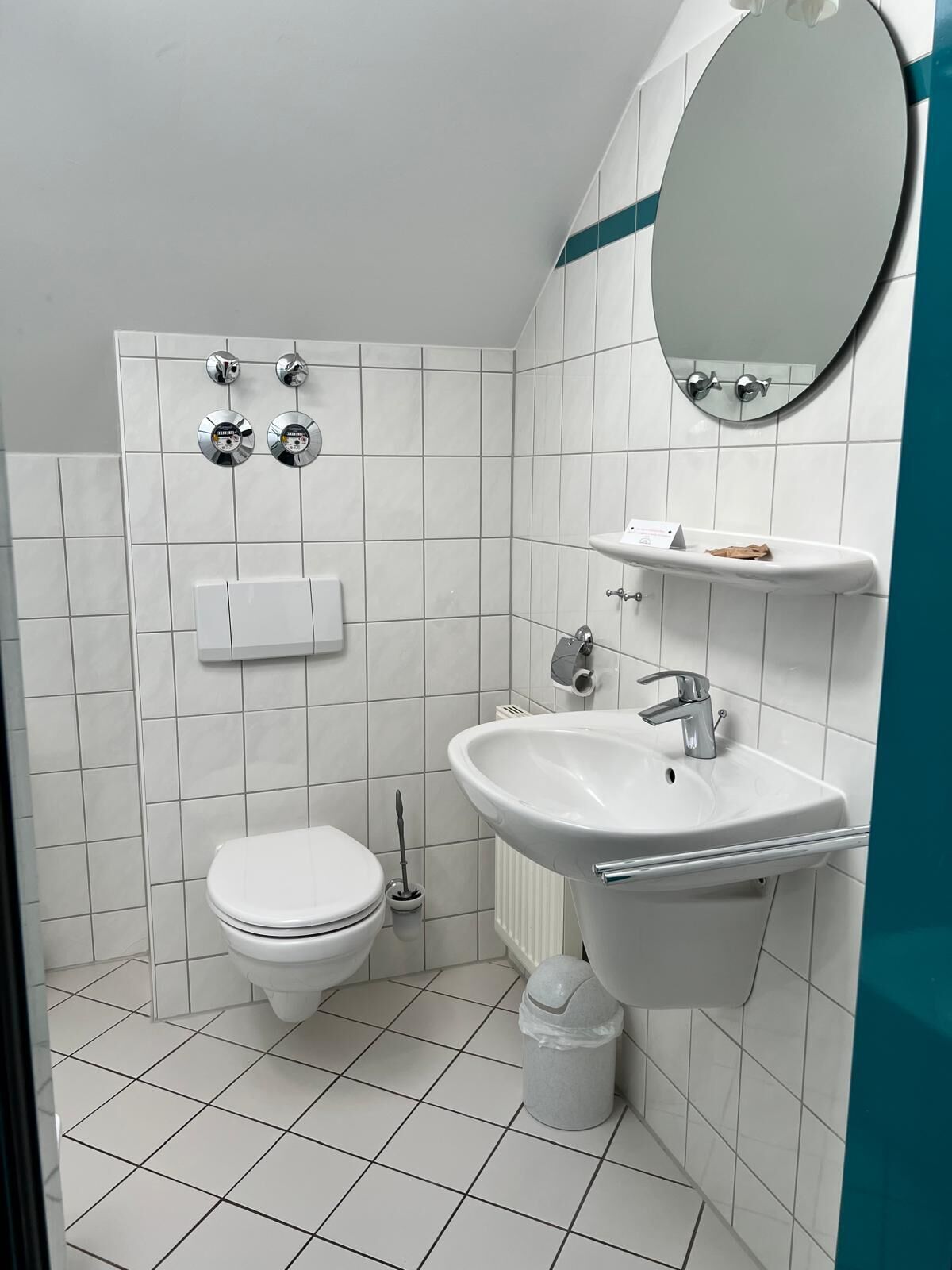 A modern bathroom with a toilet, bidet, and sink.