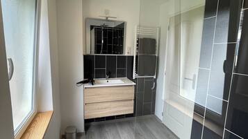 Shower, hair dryer, towels, toilet paper