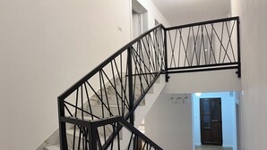 A staircase with black metal railings and marble steps. - Casuta de pe Ses (Novaci)