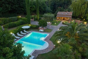 A swimming pool surrounded by a stone deck, with lounge chairs and a small house with a tiled roof. - Villa Soleil – 3 bedrooms, pool, pets allowed, A/C, Wi-Fi (Montemaggiore al Metauro)