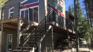 A two-story building with a balcony and stairs.