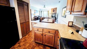 A kitchen with wooden cabinets, a countertop, and a built-in oven. - Holly 6 | Fireplace, Restaurant, Pool, Spa (Blowing Rock)