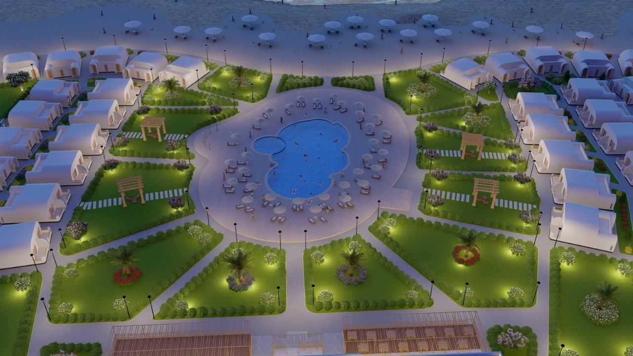 Ein Resort mit mehreren bungalowsartigen Unterkünften, einem zentralen Swimmingpool und angelegten Gärten.