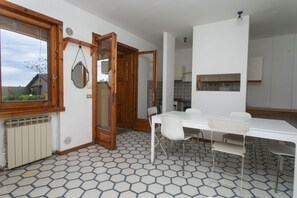 A modern kitchen with white cabinets, a white countertop, and a window. - M048 – Marcelli, three-room apartment with sea view and garden (Marcelli)