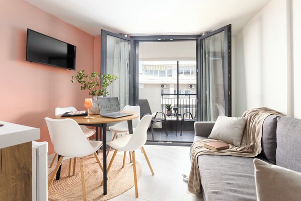 Deluxe Apartment, City View | Living area | 32-inch Smart TV with digital channels