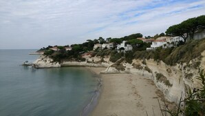 Zona costera con casas construidas sobre un acantilado con vista al mar.
