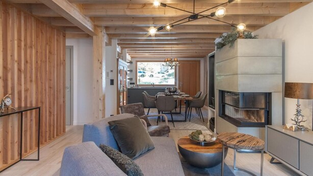 A modern living room with a wooden ceiling, a sofa, a dining area, and a fireplace. - Terrace, balcony, fireplace or stove, tv, 115m², Vars (Vars)