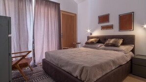 A bedroom with a large bed, a wooden chair, a desk, and a wardrobe. - Terrace, balcony, fireplace or stove, tv, 115m², Vars (Vars)