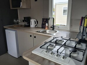 Fridge, microwave, stovetop, coffee/tea maker