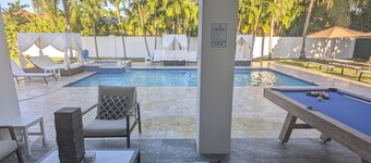 This Miami Vice Villa home is a stunning Saltwater Heated pool/Jacuzzi spa Oasis
