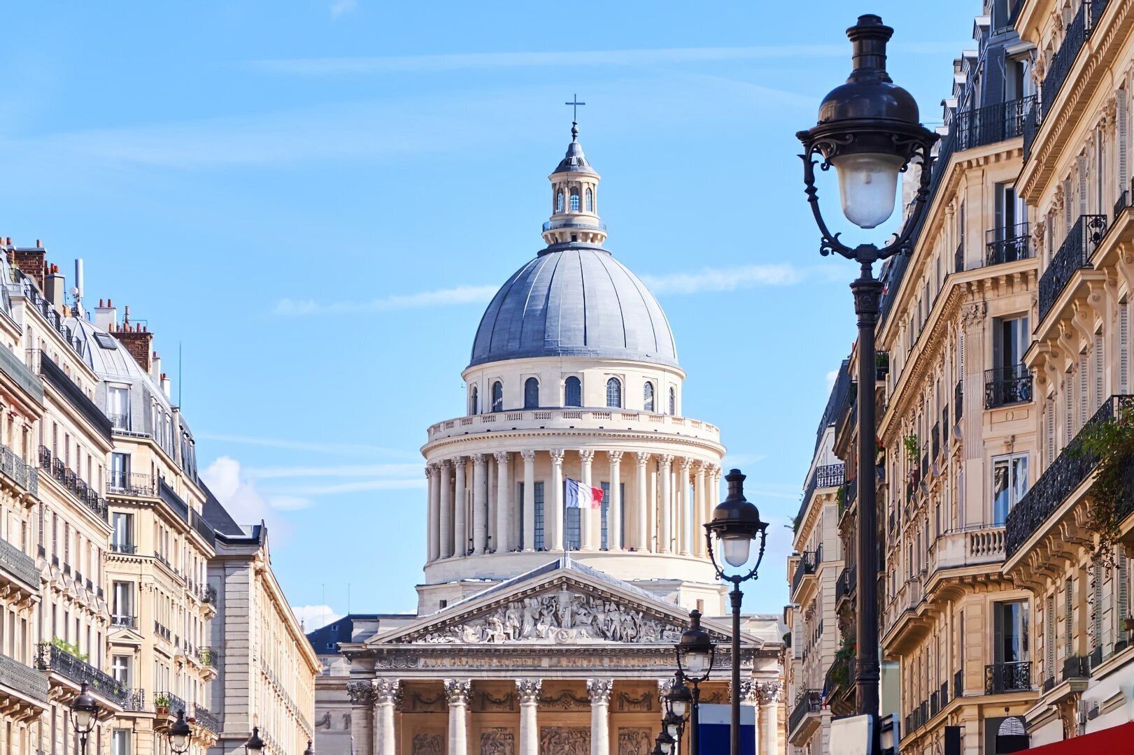 A classical building with a prominent dome and columns, surrounded by classic European architecture.