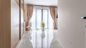 A modern interior with a marble floor, large windows with curtains, and a potted plant. - TERANGA ROOF-TOP MAMELLES, DAKAR (Dakar)