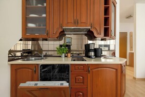 Fridge, stovetop, dishwasher, coffee/tea maker