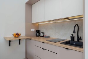 Fridge, stovetop, coffee/tea maker, cookware/dishes/utensils