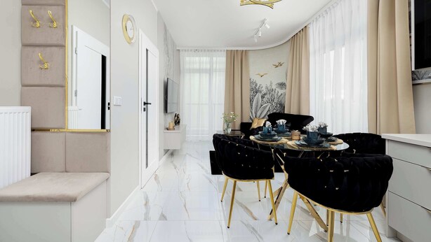 A modern dining area with a marble floor, black velvet chairs, and a gold chandelier.