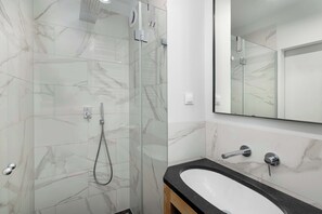 Shower, hair dryer, towels, shampoo