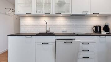 Fridge, stovetop, dishwasher, coffee/tea maker