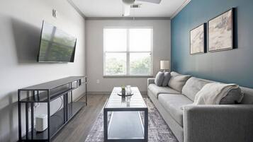 Apartment, 1 Bedroom | Living area | 50-inch TV with digital channels