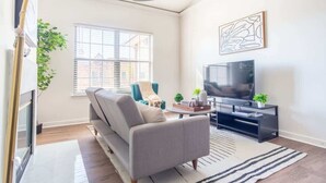 A modern living room with a sofa, a TV, and a coffee table.