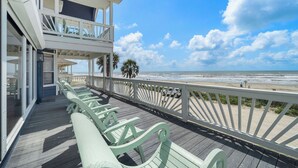 A wooden deck with benches overlooking a beach. - Ocean View by Ryson Vacation Rentals (Galveston)