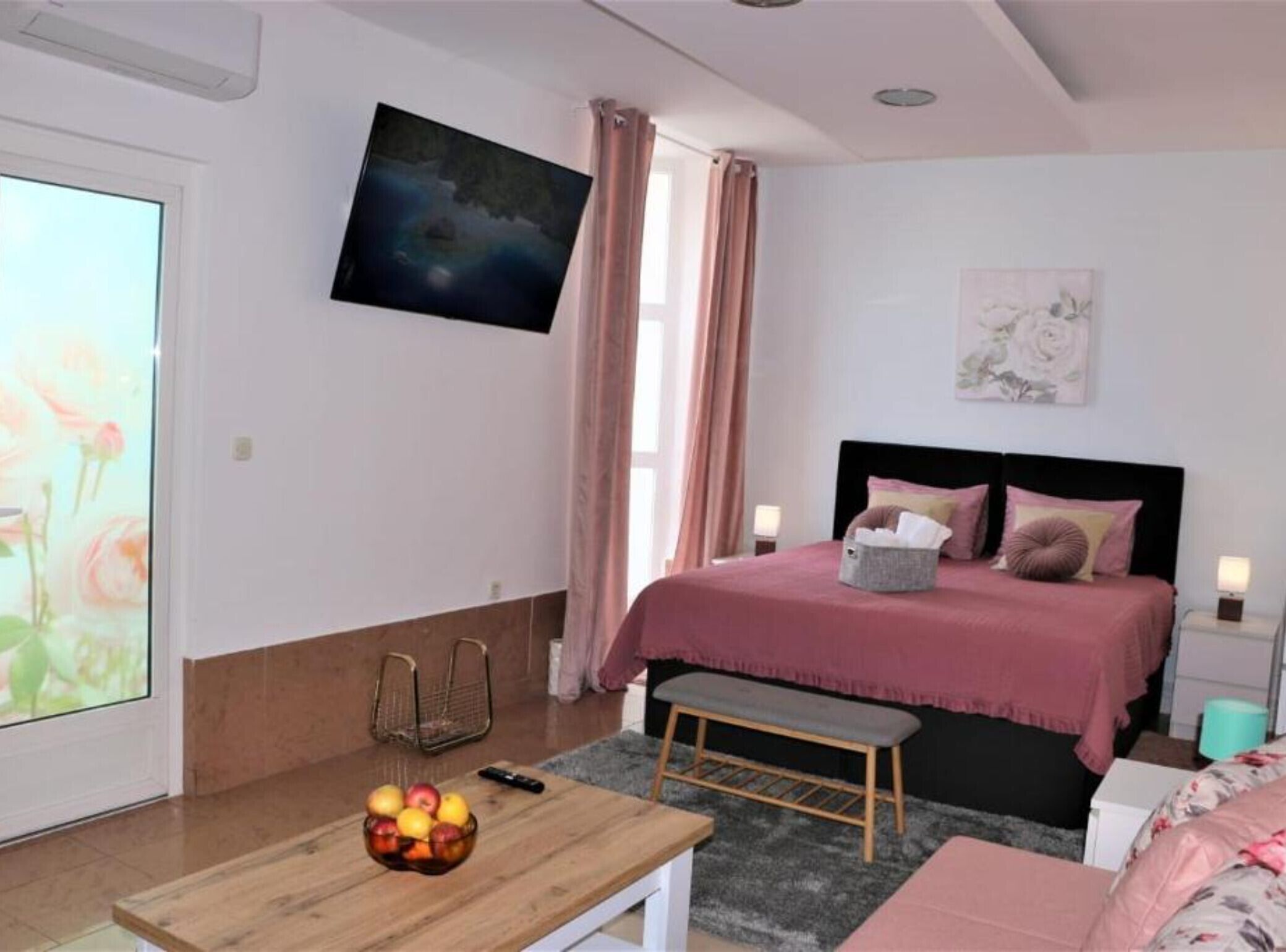 A bedroom with a bed, bedside table, and a fruit bowl.