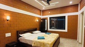 A bedroom with a bed, a ceiling fan, and a window with blinds.