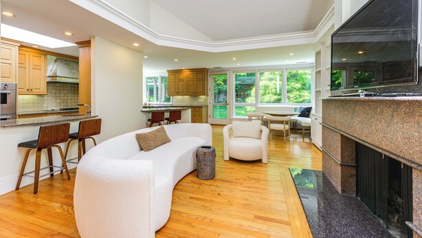 A modern kitchen with wooden cabinets, a built-in oven, and a large window. - 18 Mi to Boston - Stylish Unit in Upscale Enclave! (Weston)